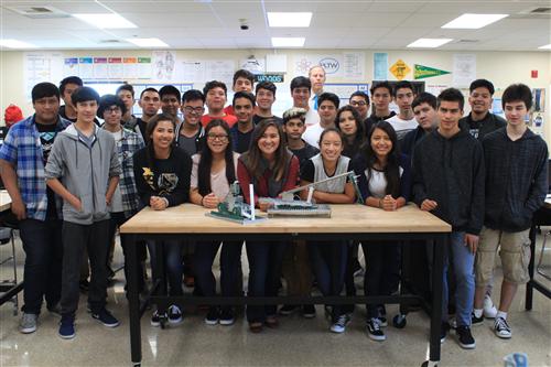 Students with mentor at a table 